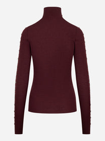 Dolcevita bordeaux in lana merinos con applicazioni su maniche