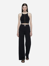 Top in maglia nero con bande in viscosa lucida con cintura